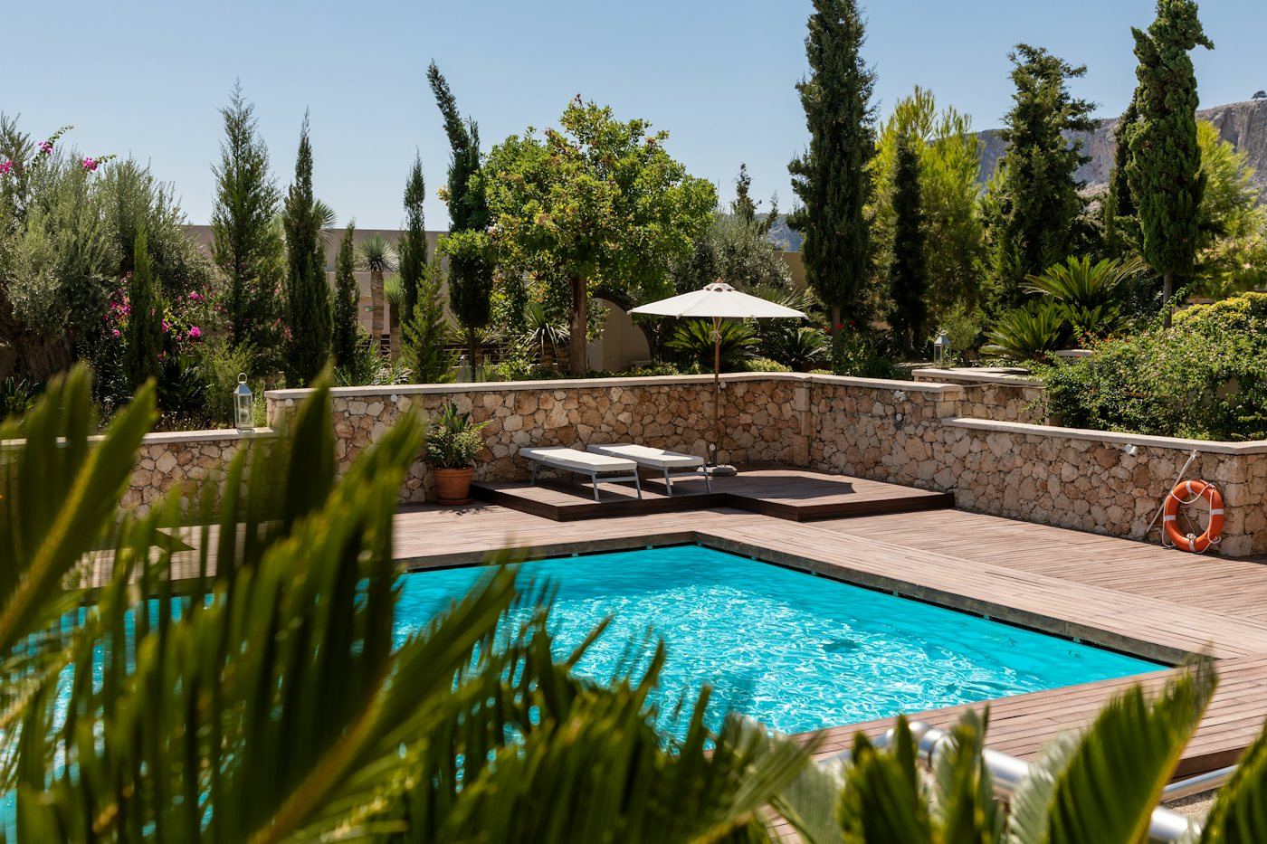 Residential swimming pool with surrounding deck in daylight
